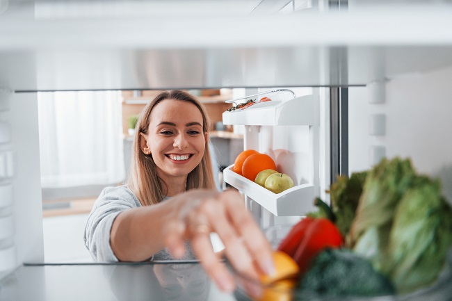 happy-woman-taking-vegetable-from-the-fridge-2022-02-03-21-15-41-utc.jpg